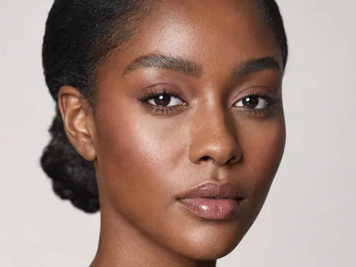 Step 2 of Wearable Clean Makeup Look, showing discoloration is softened while natural skin remains visible around the perimeter of the face.