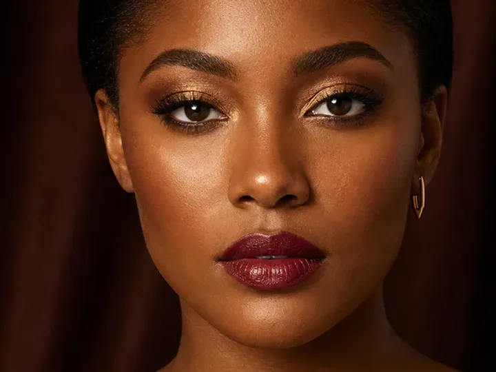 Step 2 of Holiday Party Shimmer Makeup, showing discoloration is softened while natural skin remains visible around the perimeter of the face.