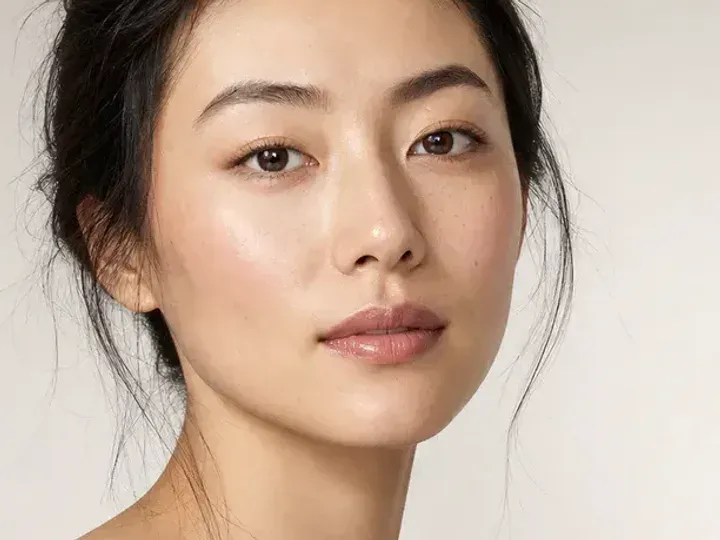 Step 2 of Natural No-Makeup Makeup, showing discoloration is softened while natural skin remains visible around the perimeter of the face.