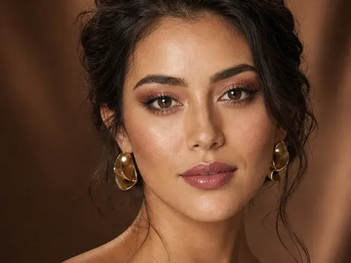Step 2 of Soft Glam Wedding Guest Makeup, showing discoloration is softened while natural skin remains visible around the perimeter of the face.