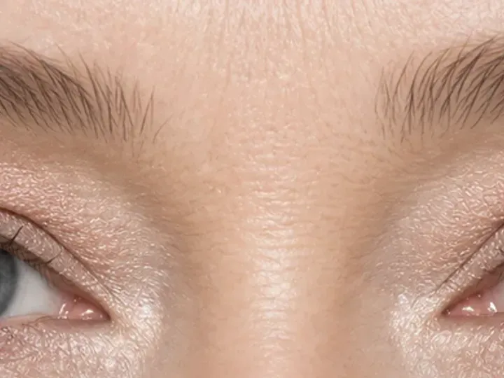 Step 2 of Balanced Eye Makeup for Close-Set Eyes, showing neutral taupe creates a soft guide at outer half of lid that remains visible with a relaxed gaze.