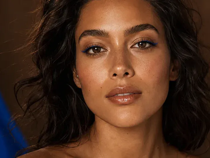Step 2 of Easy Vacation Makeup, showing discoloration is softened while natural skin remains visible around the perimeter of the face.