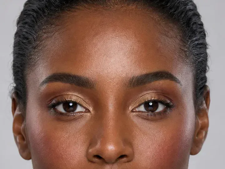 Step 3 of Rich Berry and Gold Makeup for Deep Skin, showing the brows look intentional but retain visible hairs and enough softness for the rest of the look.