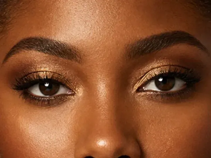 Step 3 of Holiday Party Shimmer Makeup, showing the brows look intentional but retain visible hairs and enough softness for the rest of the look.