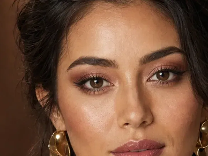 Step 4 of Soft Glam Wedding Guest Makeup, showing mushroom taupe establishes the eye direction at above the natural crease without a hard outer edge.