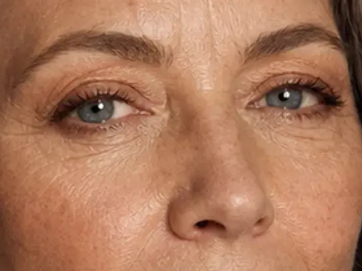 Step 5 of Natural Makeup for Mature Skin, showing soft taupe makes the lashes look denser while the eye color and lid space stay visible.