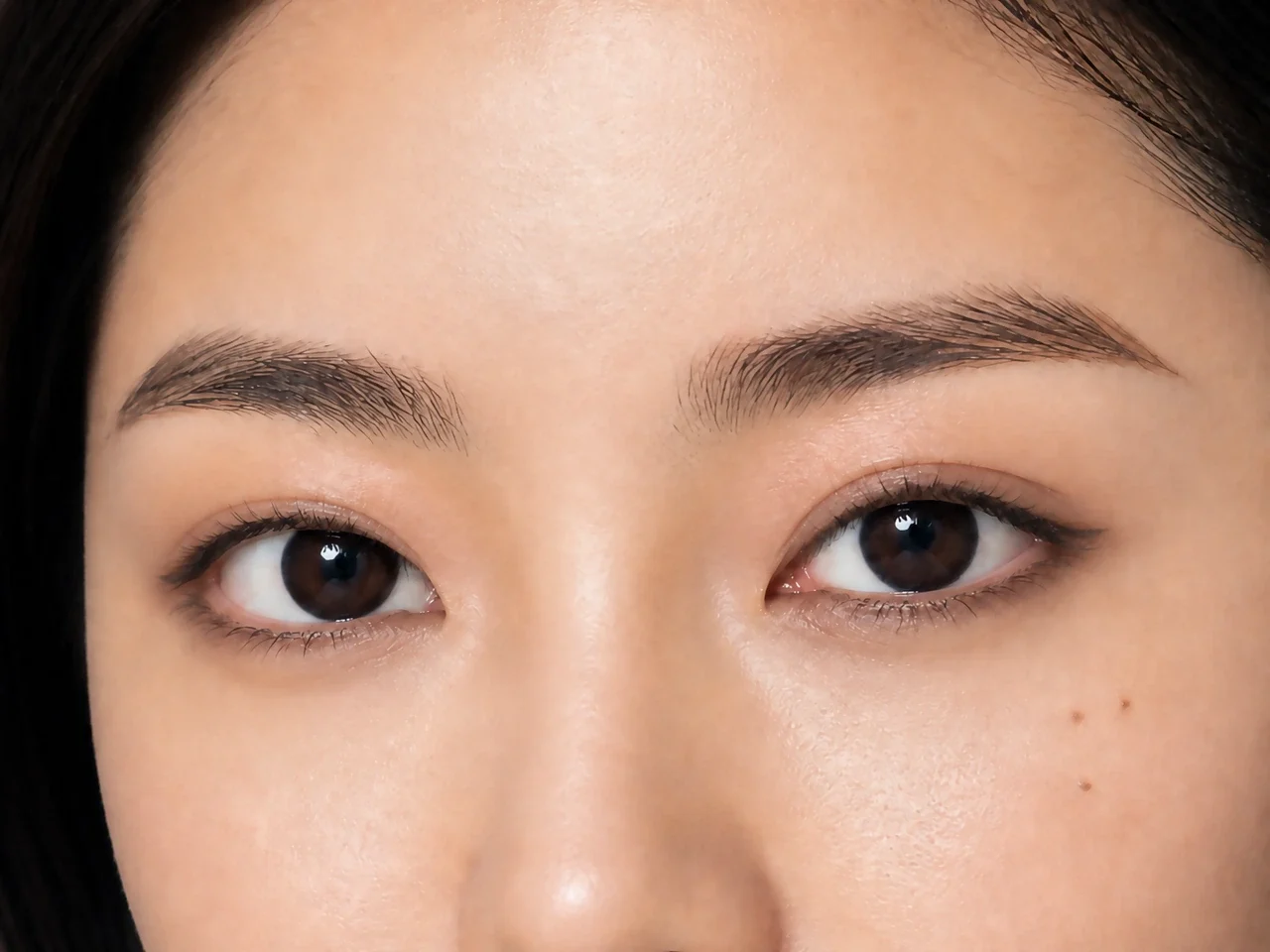 Step 6 of Elongated Eye Makeup for Round Eyes, showing a restrained lower-lash echo connects the palette without closing the inner corner or pulling the eye down.