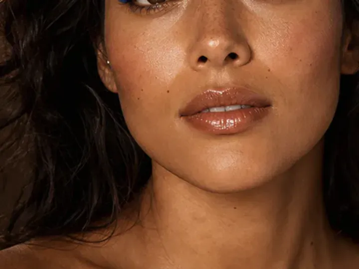 Step 6 of Easy Vacation Makeup, showing sheer bronze is visible at lid and outer cheek while natural skin still shows through the edges.