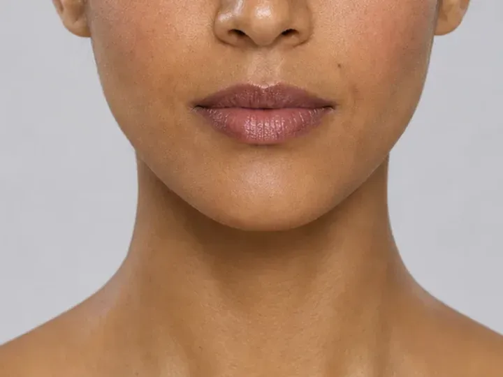 Step 6 of Neutral Soft Glam for Olive Skin, showing mauve brown is visible at upper cheek and lips while natural skin still shows through the edges.