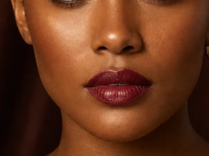 Step 6 of Holiday Party Shimmer Makeup, showing deep berry is visible at lips and upper cheek while natural skin still shows through the edges.