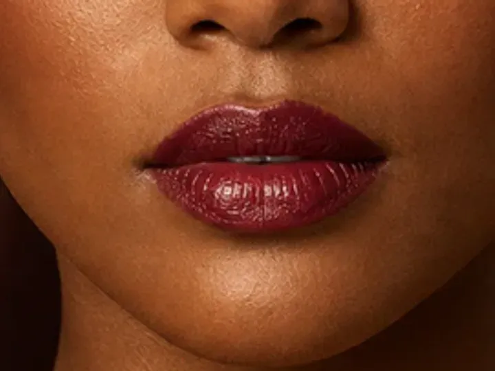 Step 7 of Holiday Party Shimmer Makeup, showing the lip supports Deep berry and the dimensional shimmer finish without becoming the only focal point.
